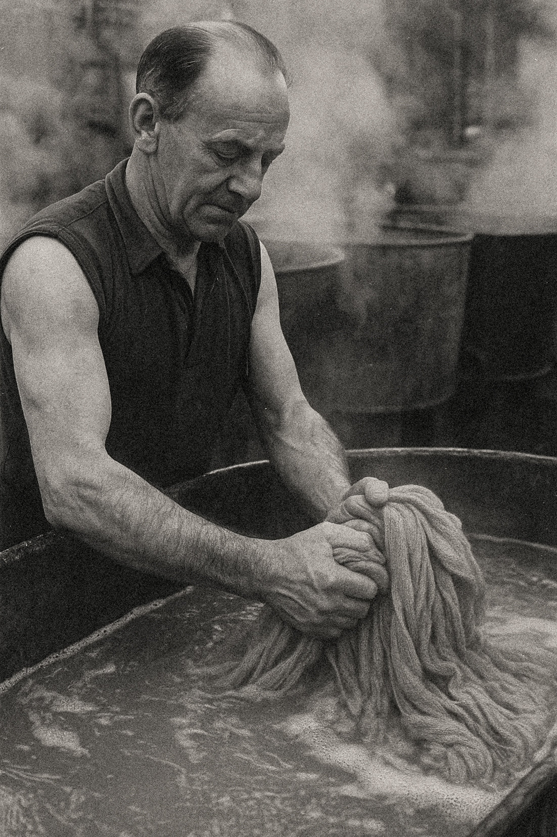 Historic black and white image showing traditional hand washing of cashmere yarn in our Scottish cashmere mill