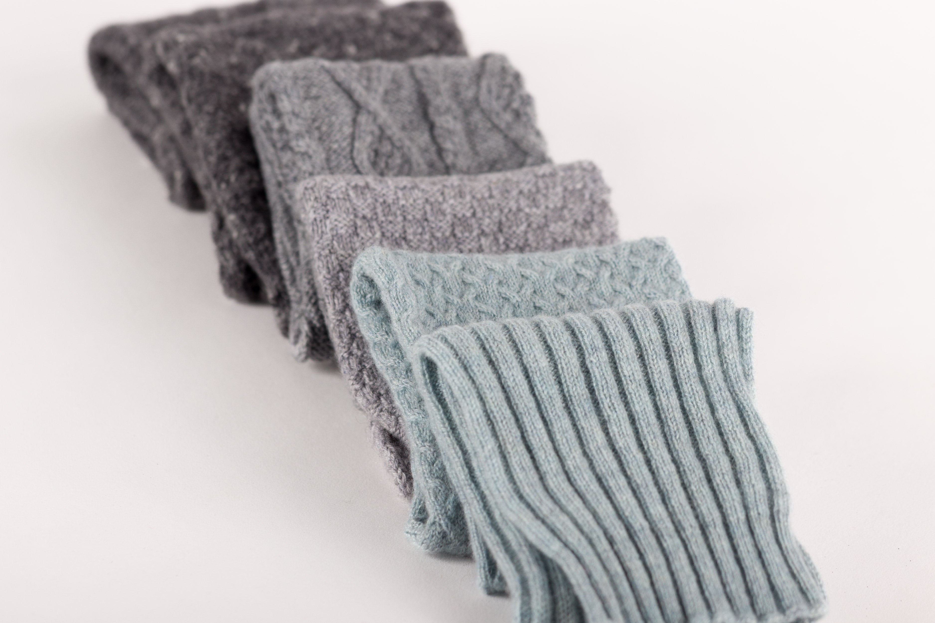 Luxury Scottish-made cashmere knitwear including ribbed snoods, knitted beanie hats, wrist warmers, scarves and Aran or staghorn cable designs